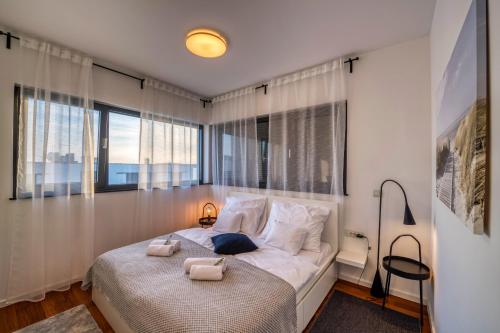 a bedroom with a bed with two towels on it at Crystal Holiday Residence in Sukošan