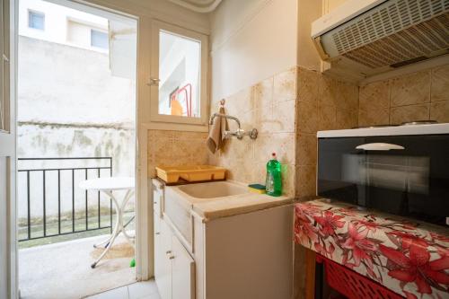 a small kitchen with a sink and a window at Zografou Apartment 1 bed 2 pers in Athens