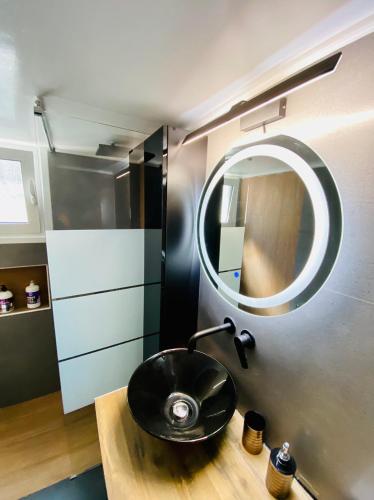 a bathroom with a black sink and a mirror at Phoenix Garden Apartments - 2 - in Athens