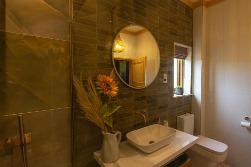 a bathroom with a sink and a mirror at Luxury Log Cabin with a Hot Tub in Stone