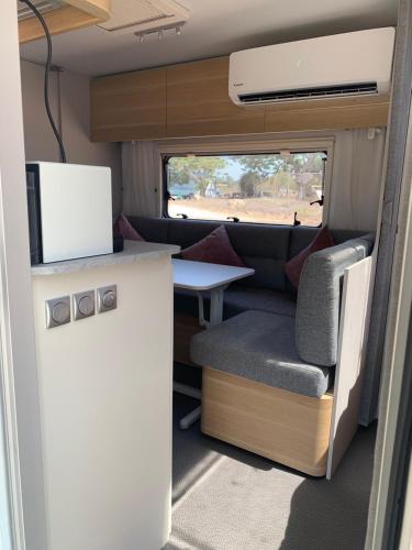 a kitchen and a table in an rv at Caravans through the nature in Mikhmoret