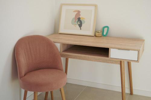 a desk with a chair and a picture on it at Birds of Paradise - Boutique Surf Lodge in Aljezur