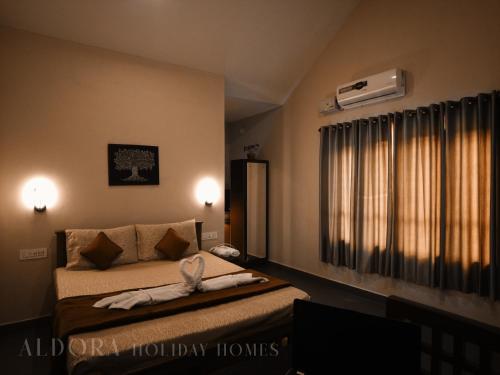 a bedroom with a bed and a window with a heater at Aldora Holiday Homes in Vythiri