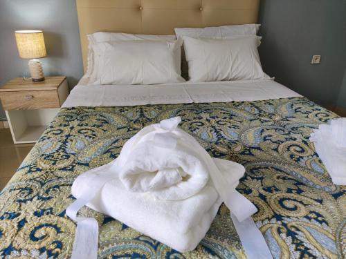 a bed with white towels on top of it at Hospitable appartment in the central park, Xanthi in Xanthi