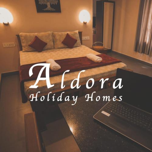 aacheloria holiday homes bedroom with a bed and a laptop at Aldora Holiday Homes in Vythiri