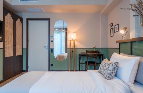 a bedroom with a white bed and a table at Giuaani Winery in Manavi
