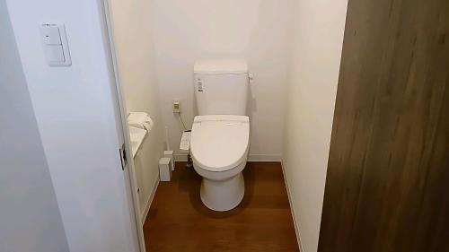 a small bathroom with a toilet and a sink at Living Inn Nahakoumae in Naha