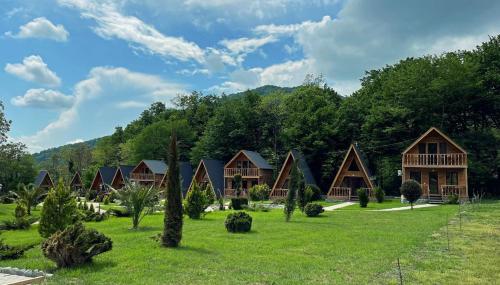 a group of houses in a field with trees at Royal Palace Hotel, Lagodekhi in Lagodekhi