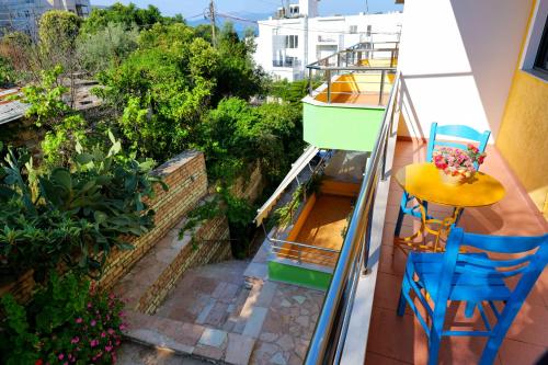 a balcony with a table and chairs and plants at Vila Lida in Sarandë