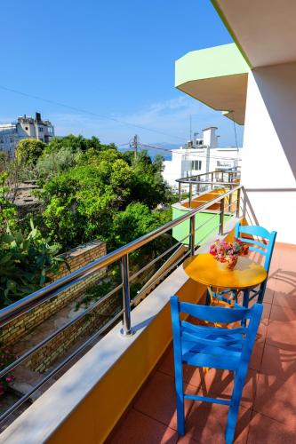a table and chairs on a balcony with a view at Vila Lida in Sarandë