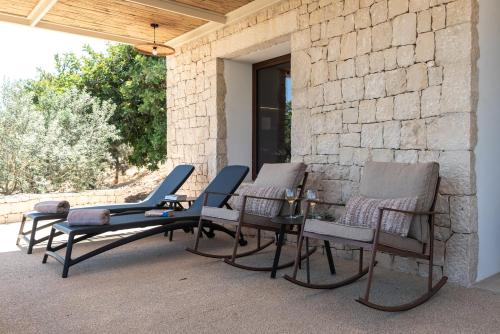 a group of chairs sitting on a patio at Relais Chiaramonte in Ragusa