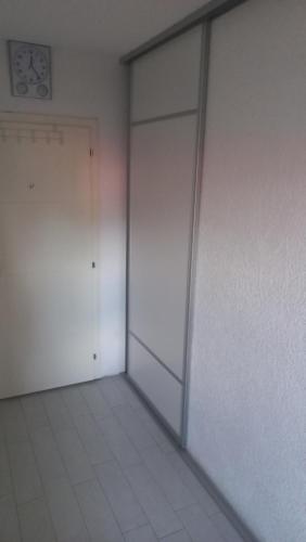 an empty room with two doors and a clock on the wall at Septemvri 7 in Kavadarci