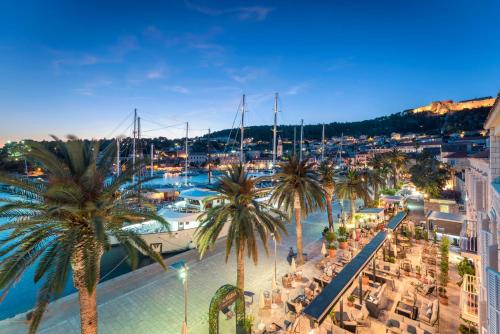 a city with lots of palm trees and boats at Riva Marina Hvar Hotel - New in June 2022 in Hvar