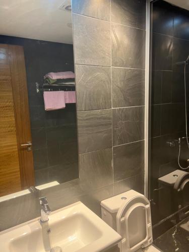 a bathroom with a sink and a toilet and a mirror at luxury apartments in Casablanca