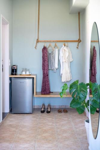 a room with a shelf with clothes and shoes at Serenity Hideaway in Palaiochóra