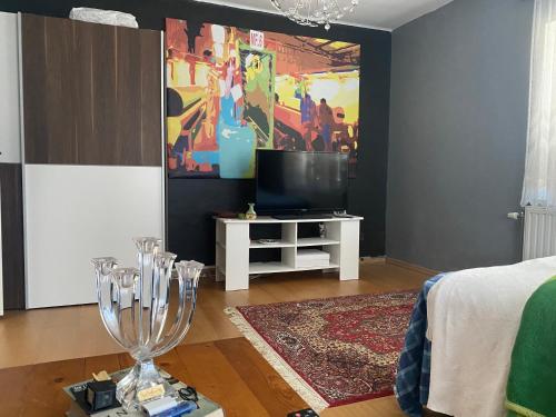 a living room with a tv and a table with wine glasses at Anita in Kristianstad