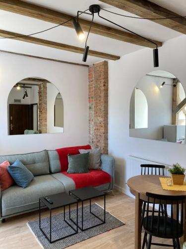a living room with a couch and a table at Przy Poznańskiej Bramie in Inowrocław