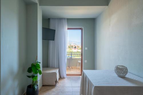 a room with a table and a door to a balcony at Serenity Hideaway in Palaiochóra
