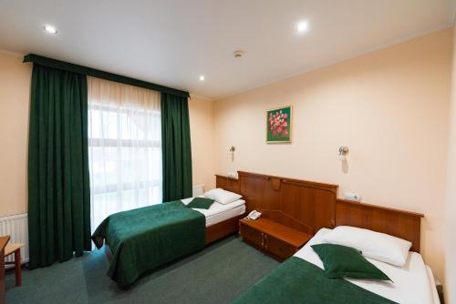 Una cama o camas en una habitación de Hotel Kopa - Lviv