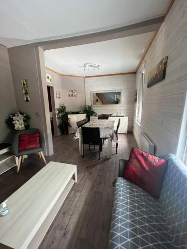 a living room with a couch and a table at APPARTEMENT 6 PERSONNES CLASSE 2 ETOILES LEBOUCQ Laurent in Fort-Mahon-Plage