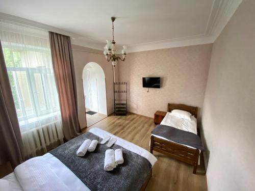 a bedroom with two beds with towels on them at Dato Khetaguri Apartment in Kazbegi