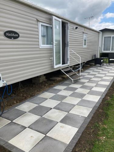 a mobile home with a checkered floor in front of it at Seaview Holiday Rentals in Whitstable