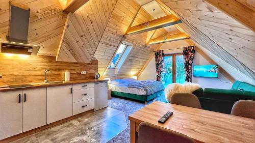 a kitchen and living room in a tiny house at Maryna Bór in Zakopane