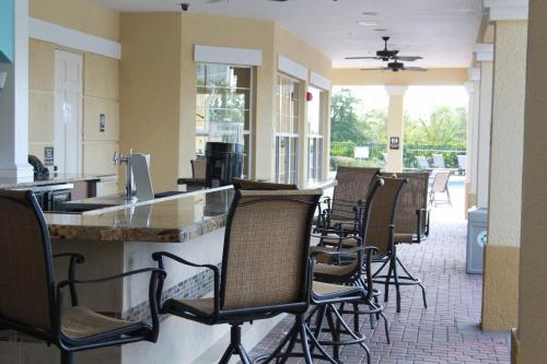 a row of chairs sitting at a bar in a restaurant at Vista Cay Inn in Orlando