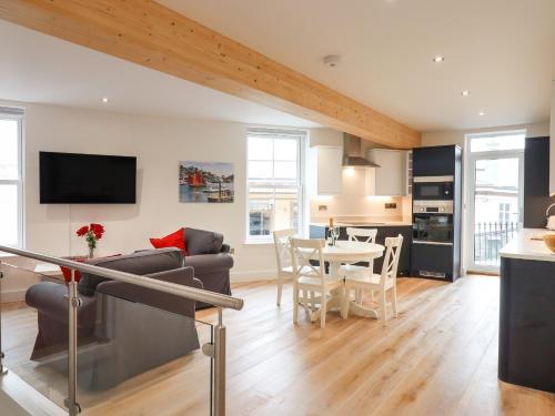 a living room with a couch and a table at Ferryside in Dartmouth