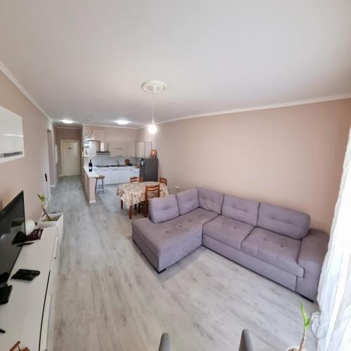 a living room with a couch and a table at Green Villa in Vlorë