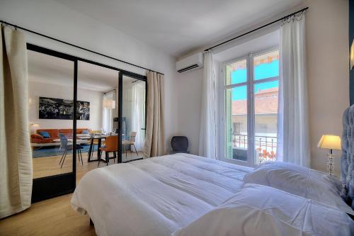 a bedroom with a large bed and a large window at Superbe 3 pieces Moderne et tres Central A2B233 in Cannes