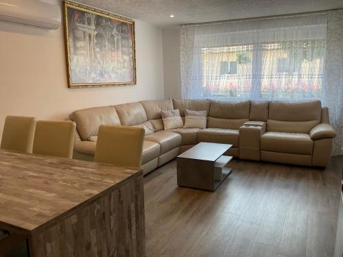 a living room with a couch and a table at Jarmila Vendégház in Balatonberény
