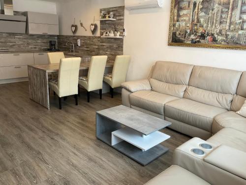a living room with a couch and a table at Jarmila Vendégház in Balatonberény