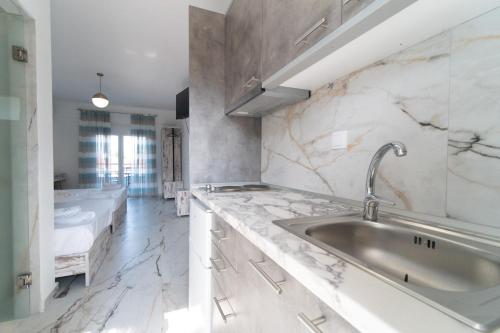 a bathroom with a sink and a bath tub at Amalthia in Skala Potamias