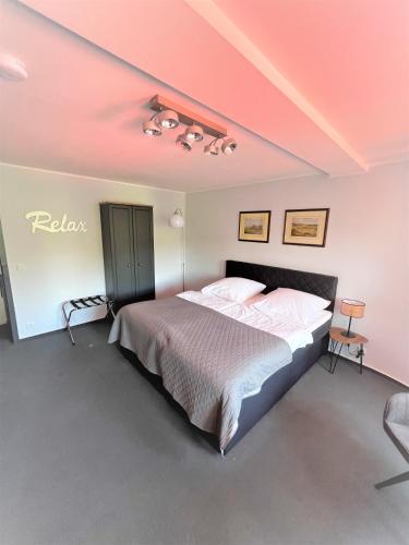 a bedroom with a bed with a pink ceiling at Aggerschlösschen in Wahlscheid