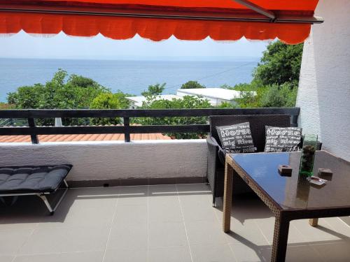 a balcony with a table and a view of the ocean at Apartments Stara Baska in Stara Baška