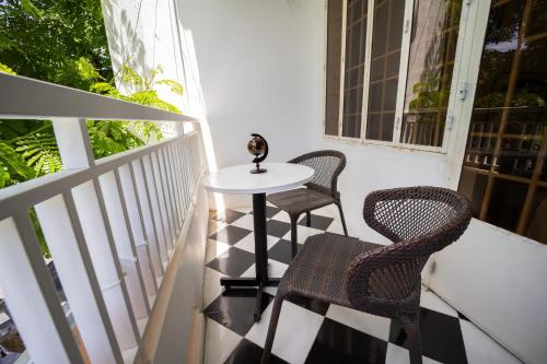 a small table and two chairs on a balcony at Nhà đầy nắng homestay in Nha Trang