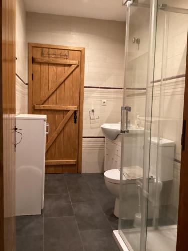 a bathroom with a toilet and a sink and a door at Quinta da Horta Nova in Elvas