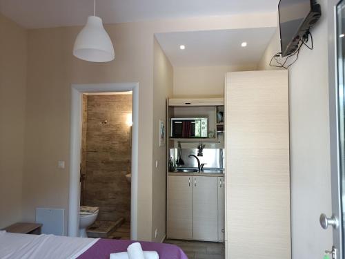 a kitchen with a white refrigerator and a white sink at Nefeli in Vasiliki