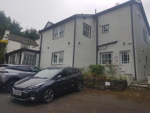 a black car parked in front of a house at Beech Apartment in Bowness-on-Windermere