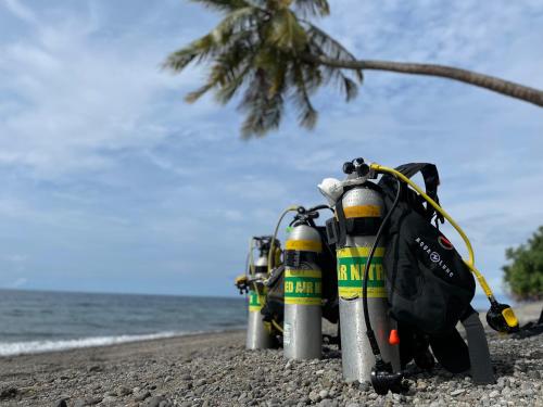 a group of fire engines sitting on the beach at Sanctum Una Una Eco Dive Resort in Pulau Unauna
