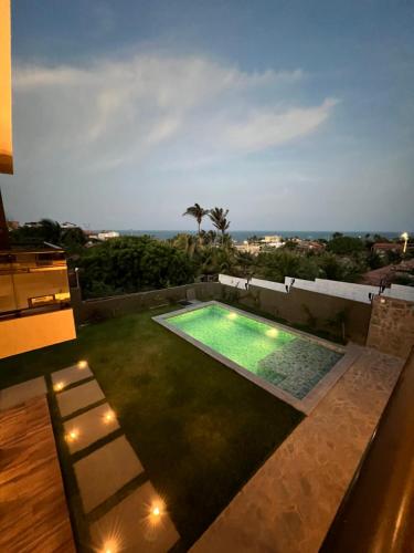 a swimming pool on the roof of a house at LUXURIOUS NEW HOUSE, UNFORGETABLE EXPERIENCE. in Canoa Quebrada