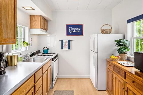 a kitchen with a white refrigerator and a sink at Seascape Motel & Cottages in Belfast