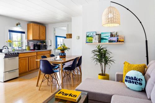 a living room and kitchen with a table and a couch at Seascape Motel & Cottages in Belfast