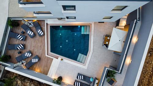 an overhead view of a living room with a pool at SunnySide luxury suites with free parking and swimming pool in Brela