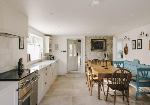 a kitchen and dining room with a table and chairs at The Workers Cottage in Great Bircham