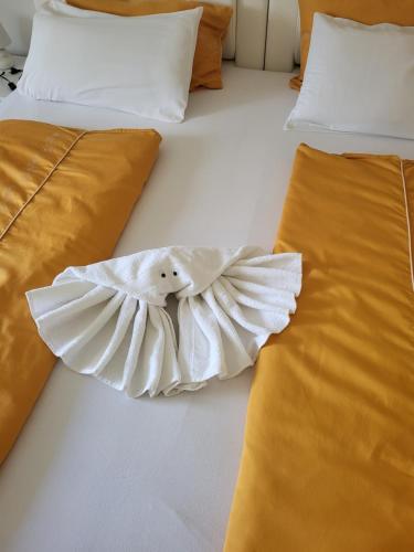 two beds with white sheets and orange pillows at Villa Nemo in Poreč