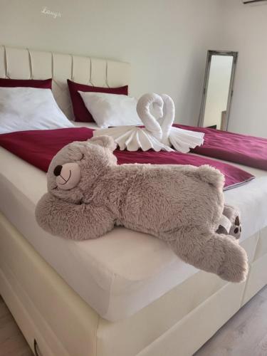 a stuffed teddy bear laying on a bed at Villa Nemo in Poreč
