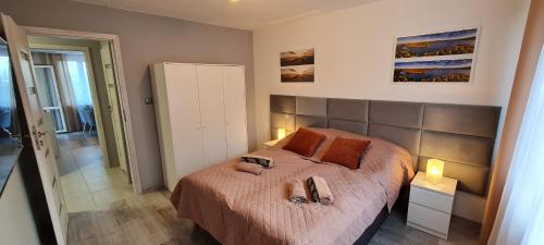 a bedroom with a bed with two slippers on it at Apartament Panorama 6 20 in Polańczyk