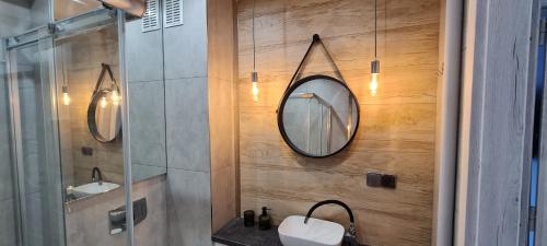 a bathroom with two sinks and a mirror on the wall at Apartament Panorama 6 20 in Polańczyk